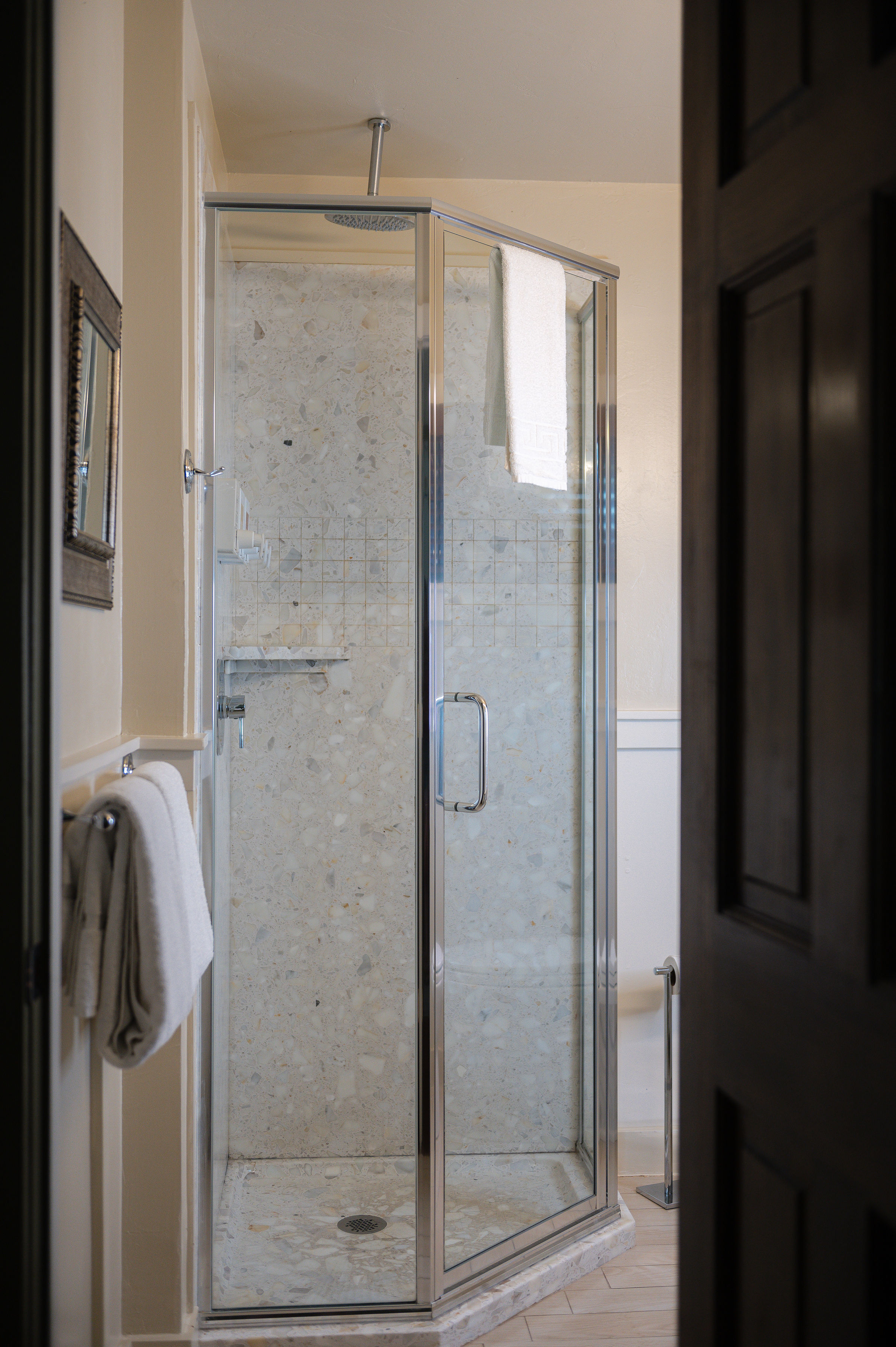 Glass corner shower with white tile