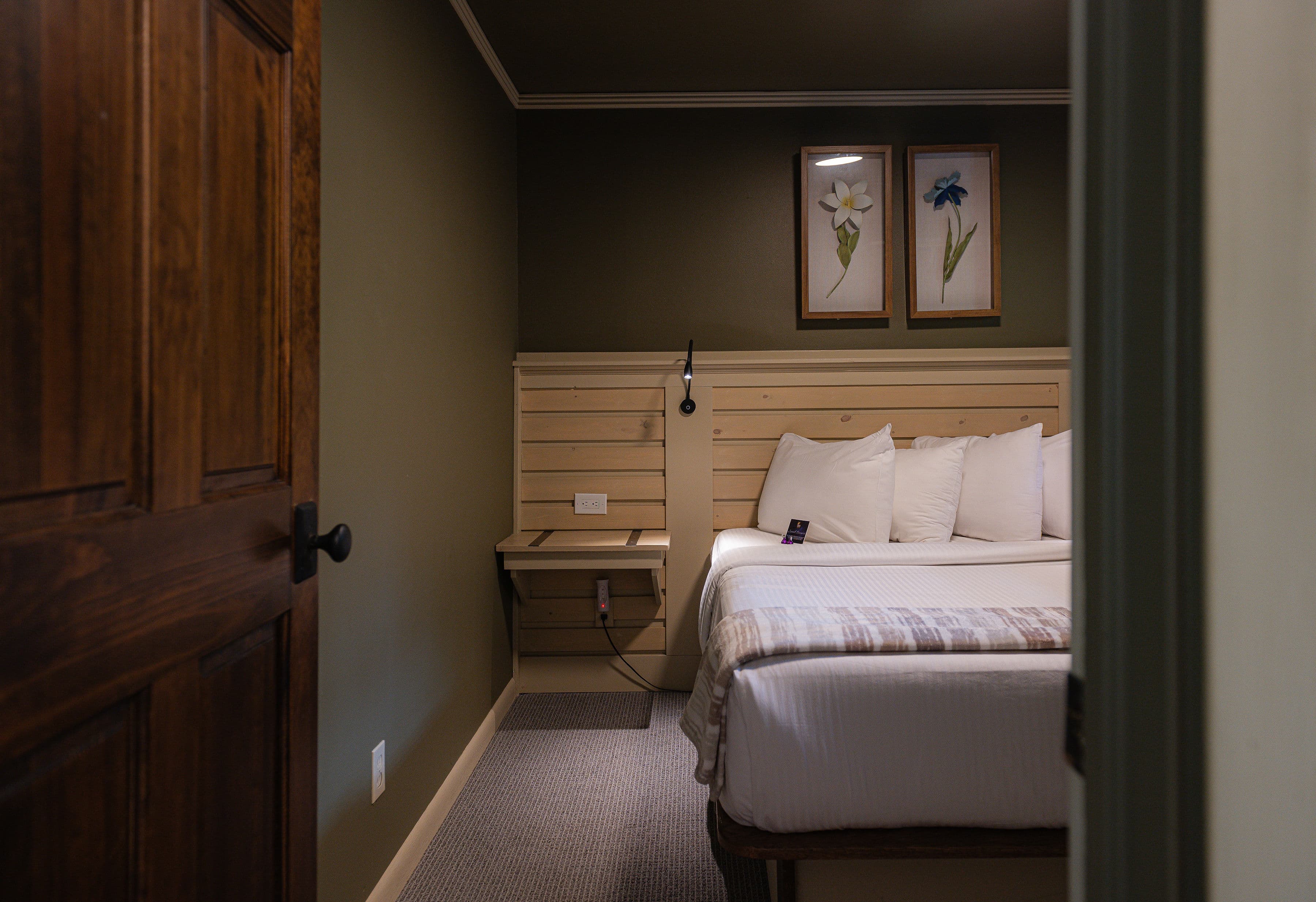 Queen Bed with gray blanket.