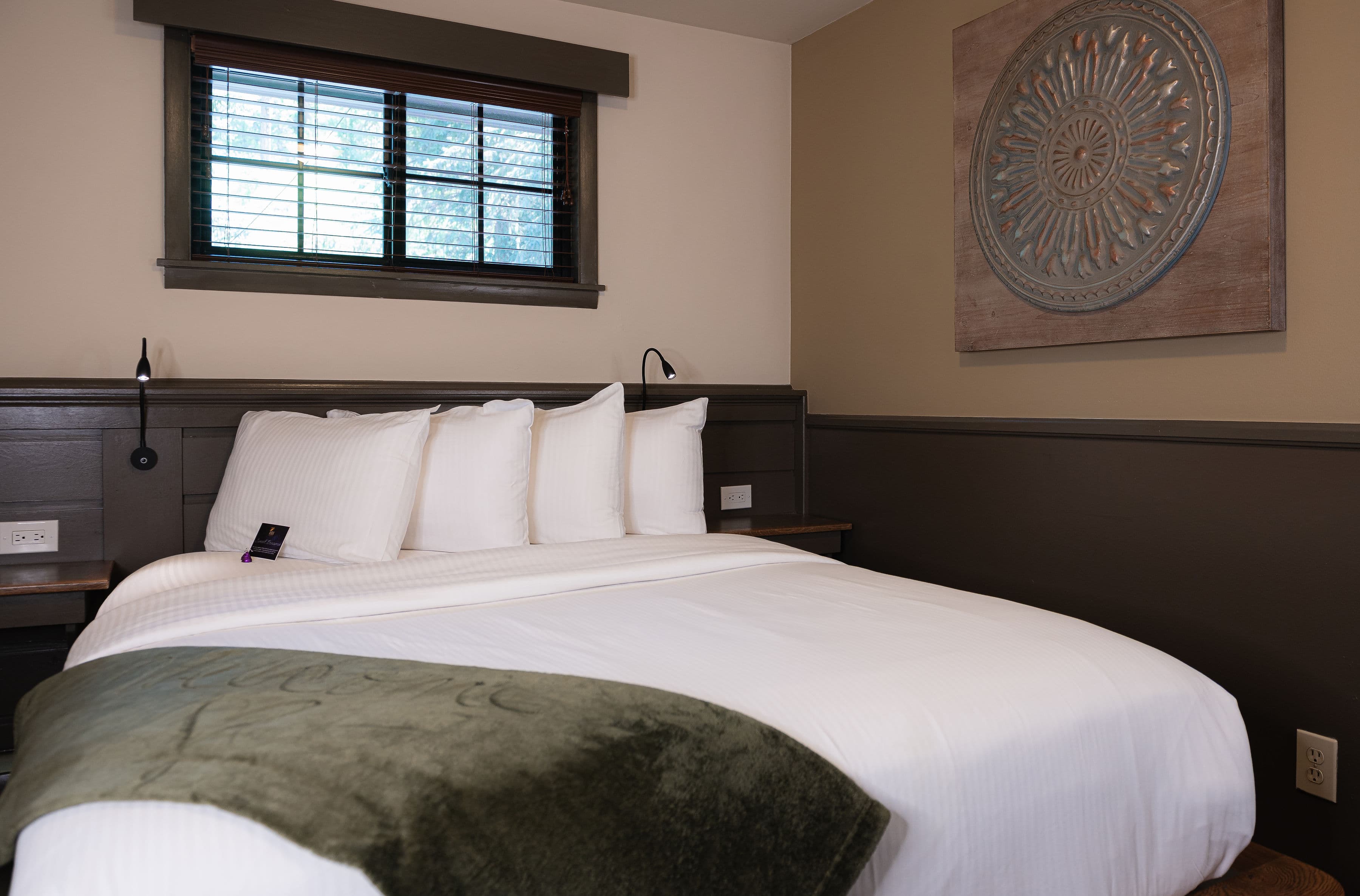 Queen bed with gray velvet blanket
