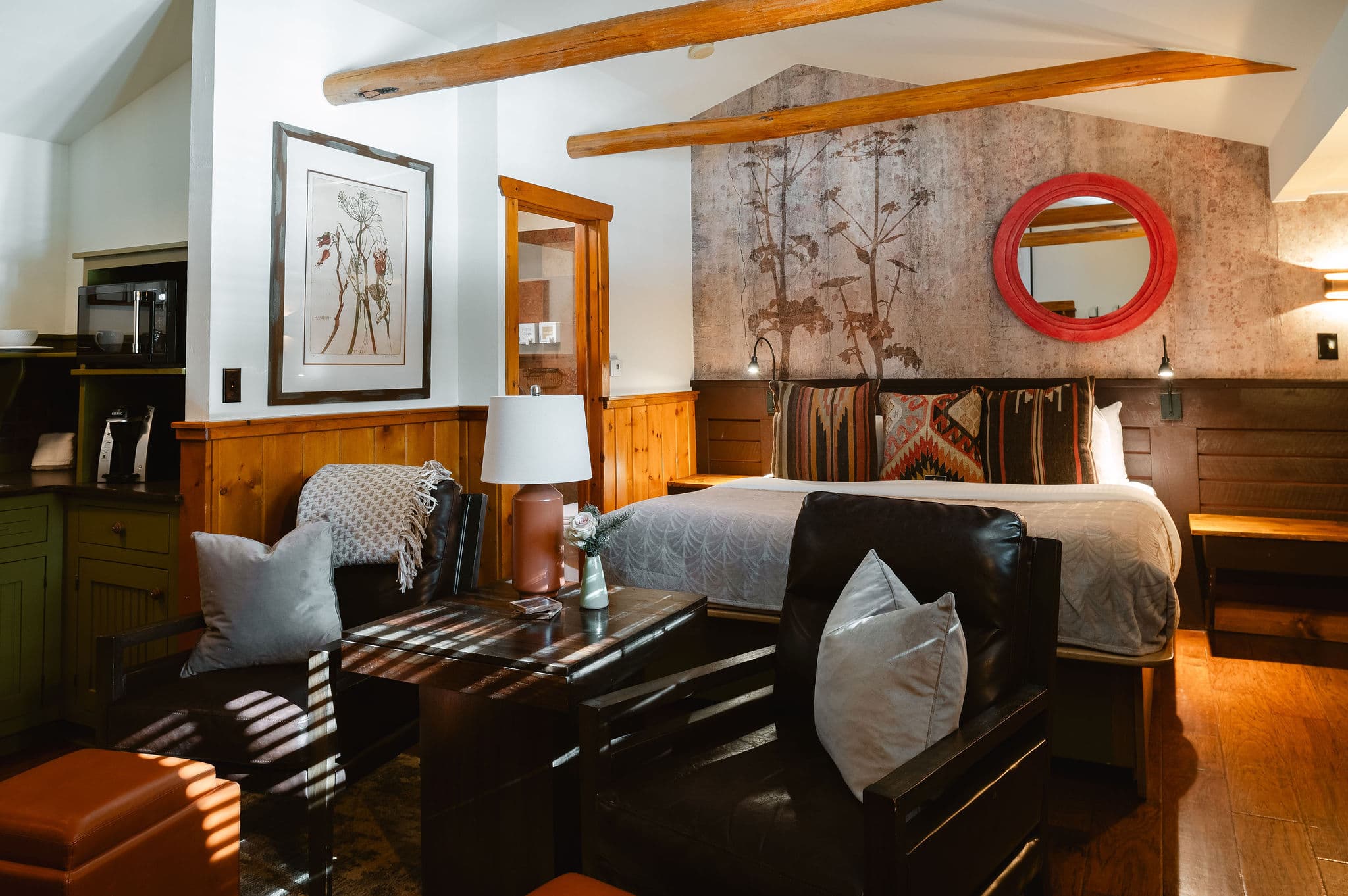 Brown leather chairs, keurig coffee pot, wood timber beams