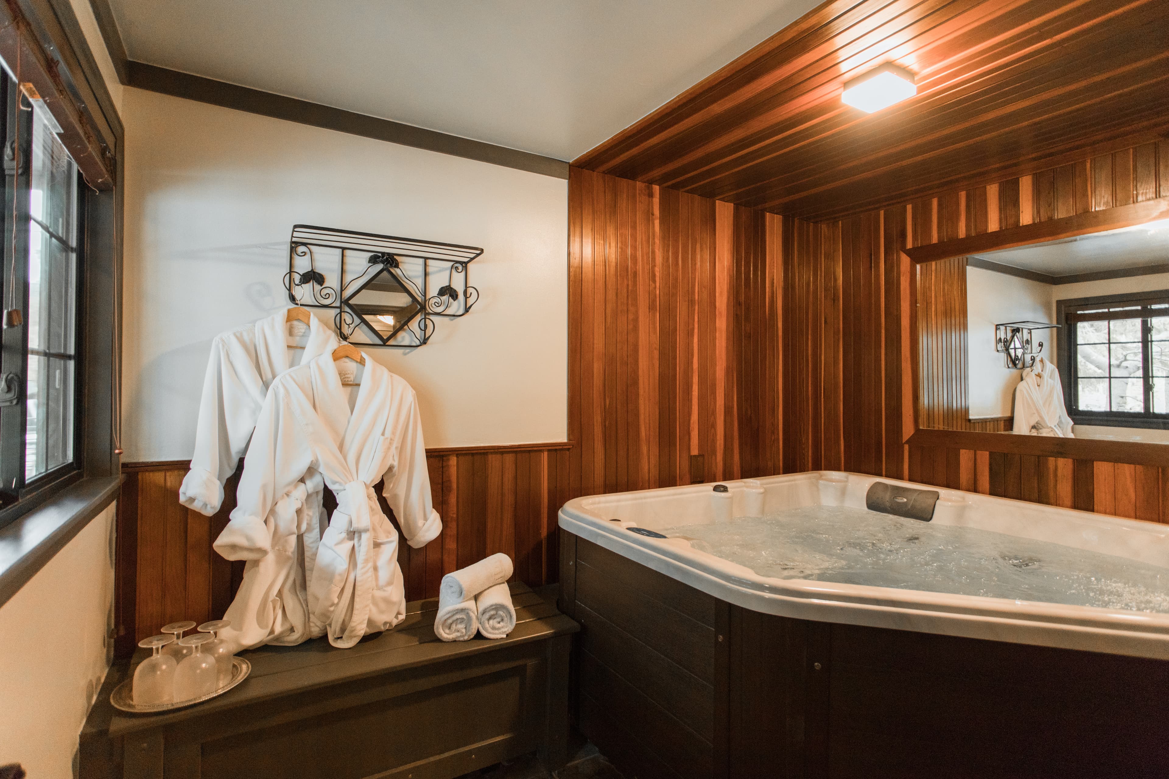 white robes, wooded room with large hot tub