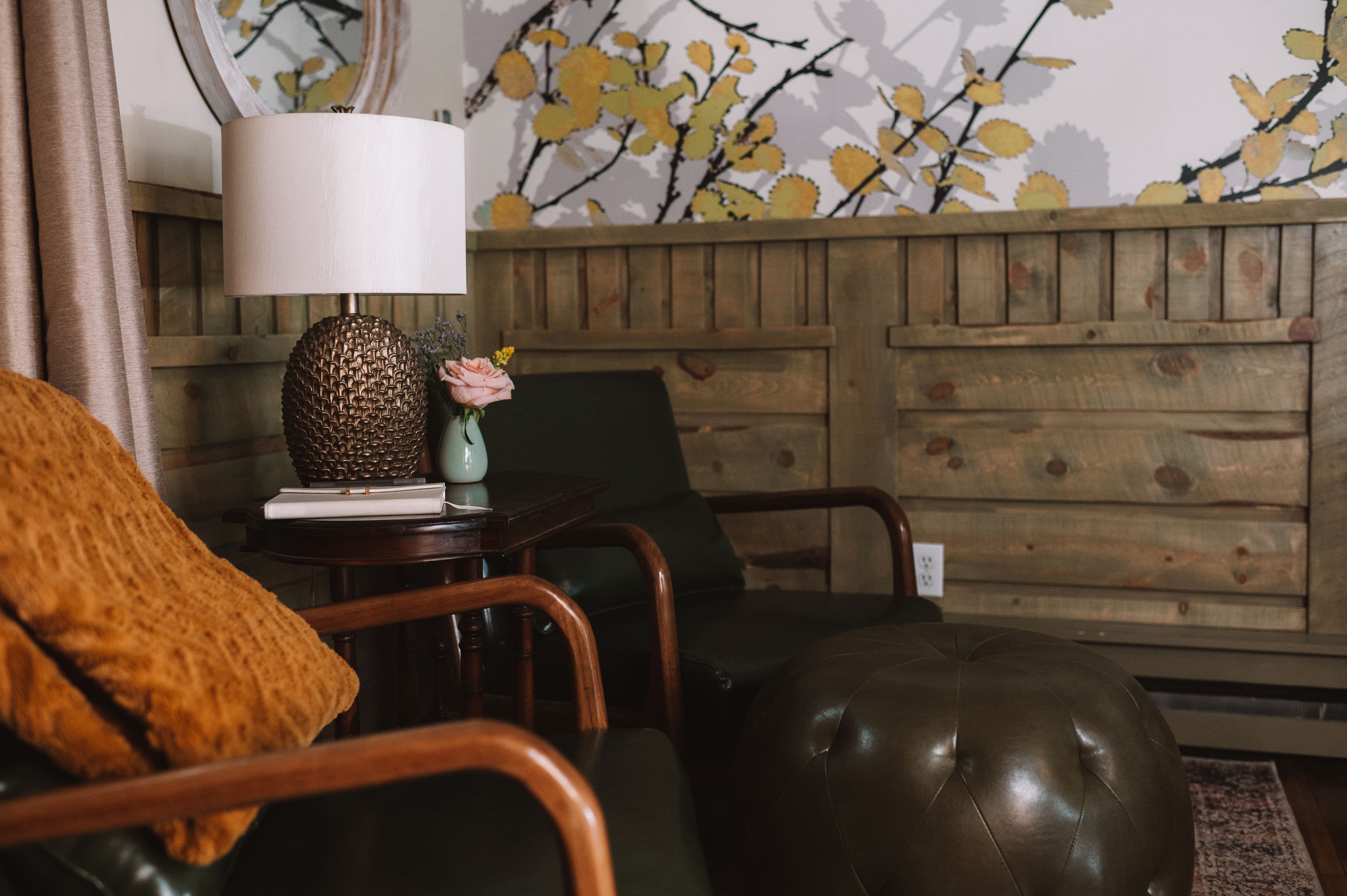 Two green leather chairs with ottoman, small table, air conditioner