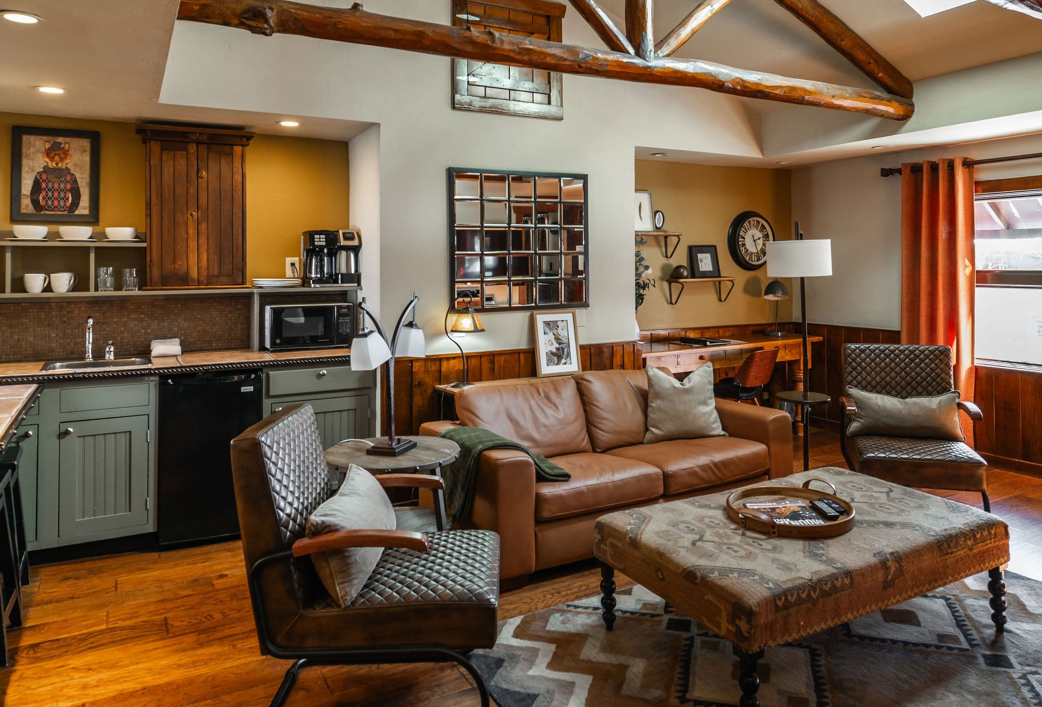 large room high ceilings, quilted leather arm chairs and table and leather loveseat