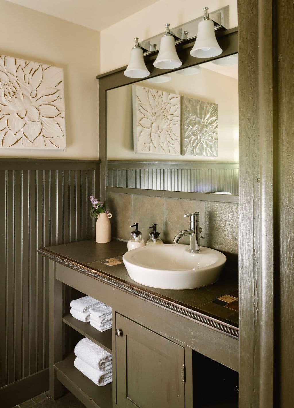 bathroom with walk-in shower, white vessel sink, and toilet.