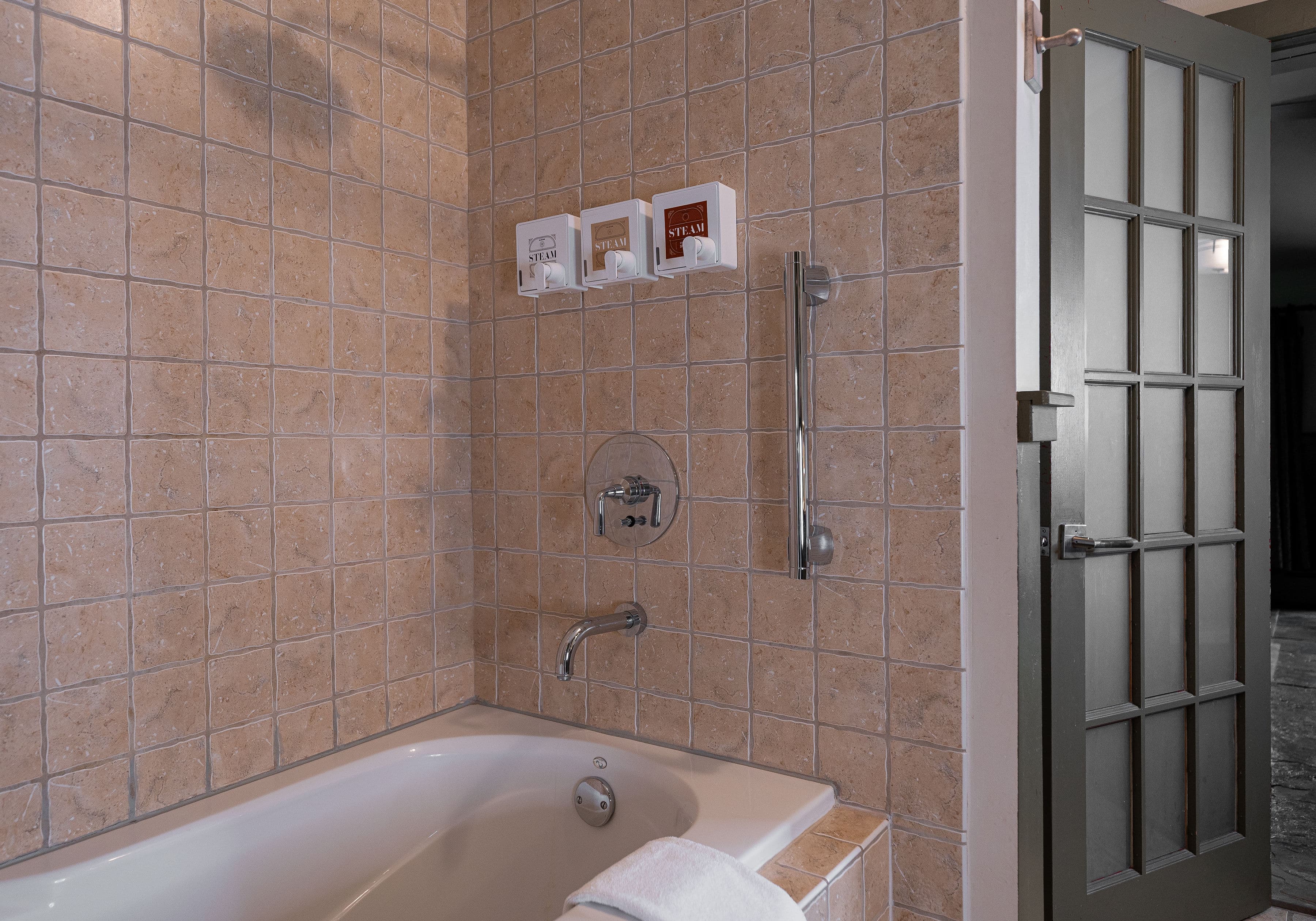 Deep one person jetted tub, with a shower.