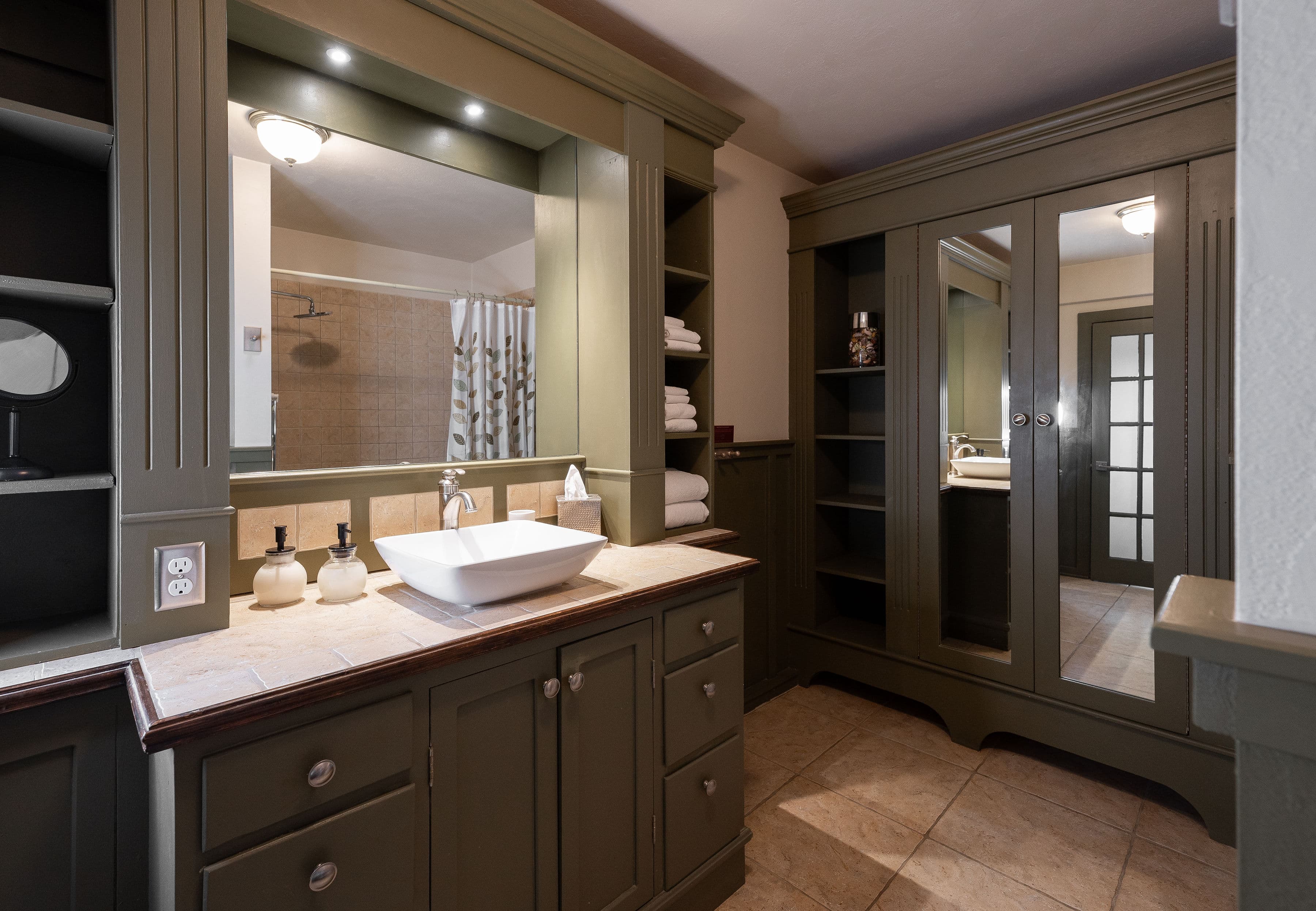 Gorgeous spacious bathroom with a vanity sink. deep one person jetted tub, with a shower. toilet, and closet with mirrors.