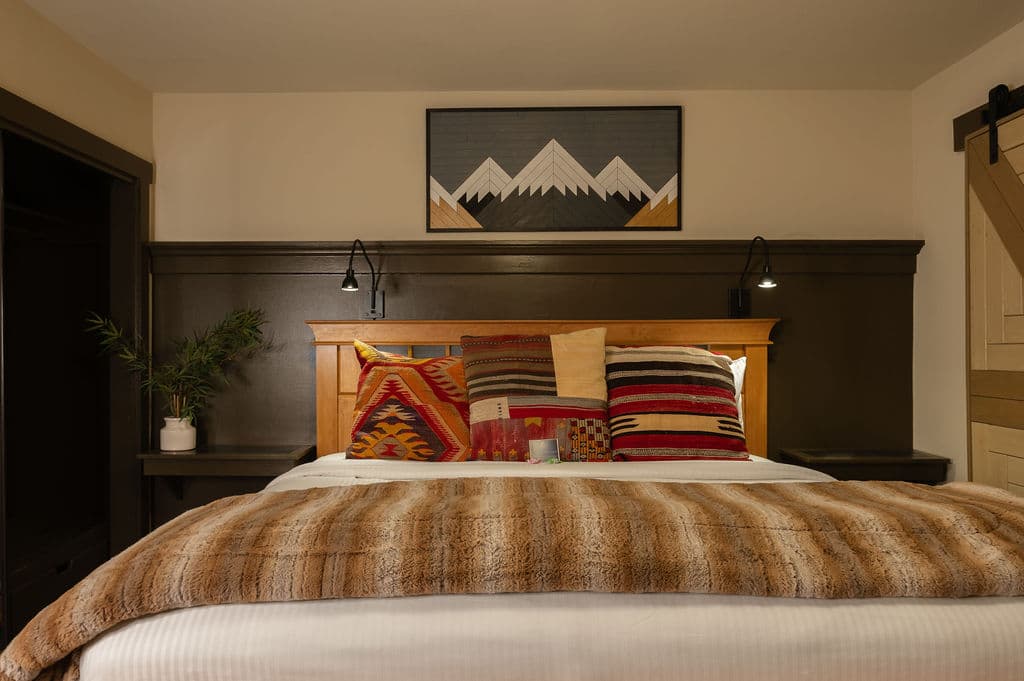 King bed, shiny taupe curtains, soft bedding