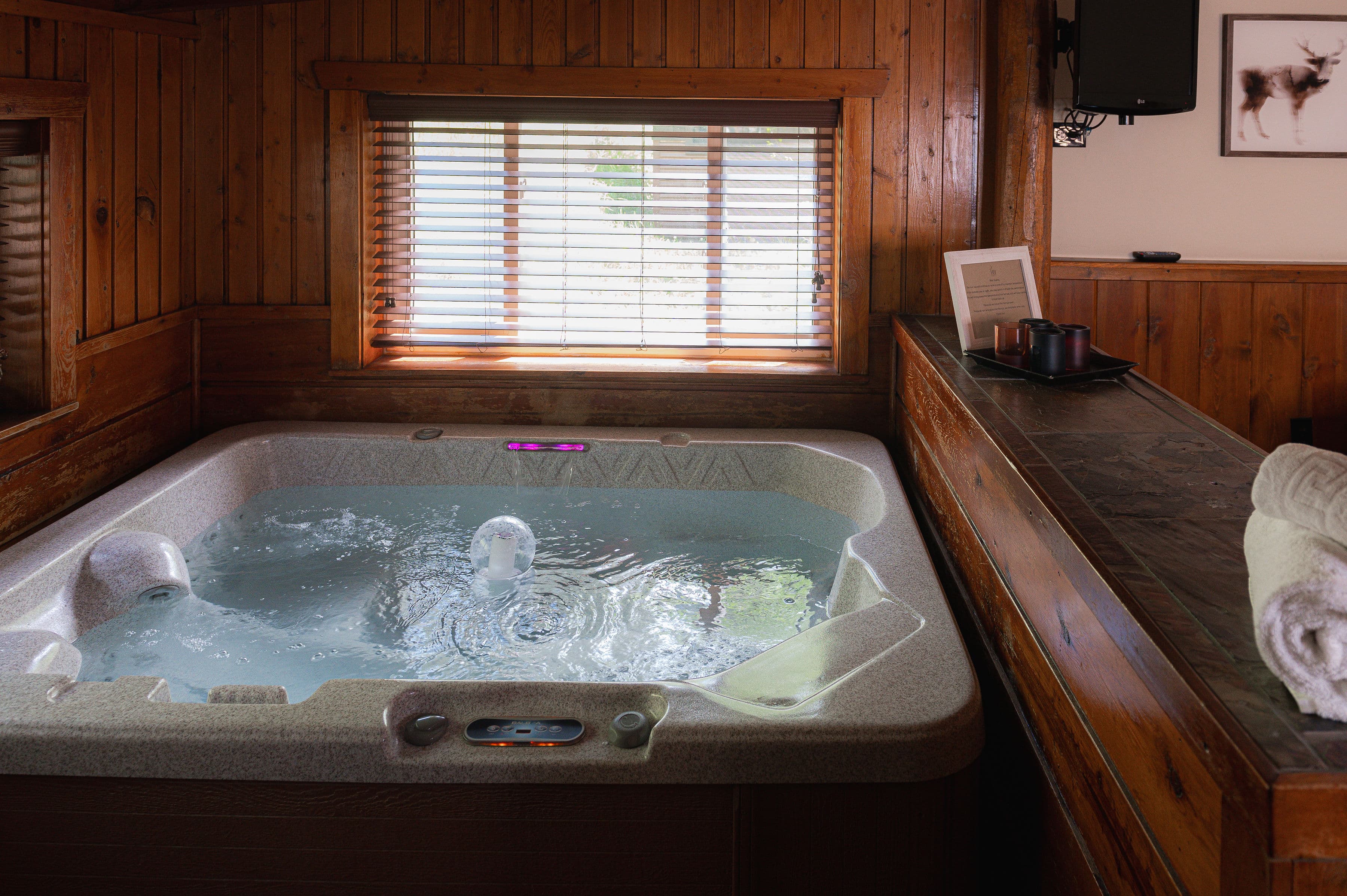 Hot tub steps down from king bed suite