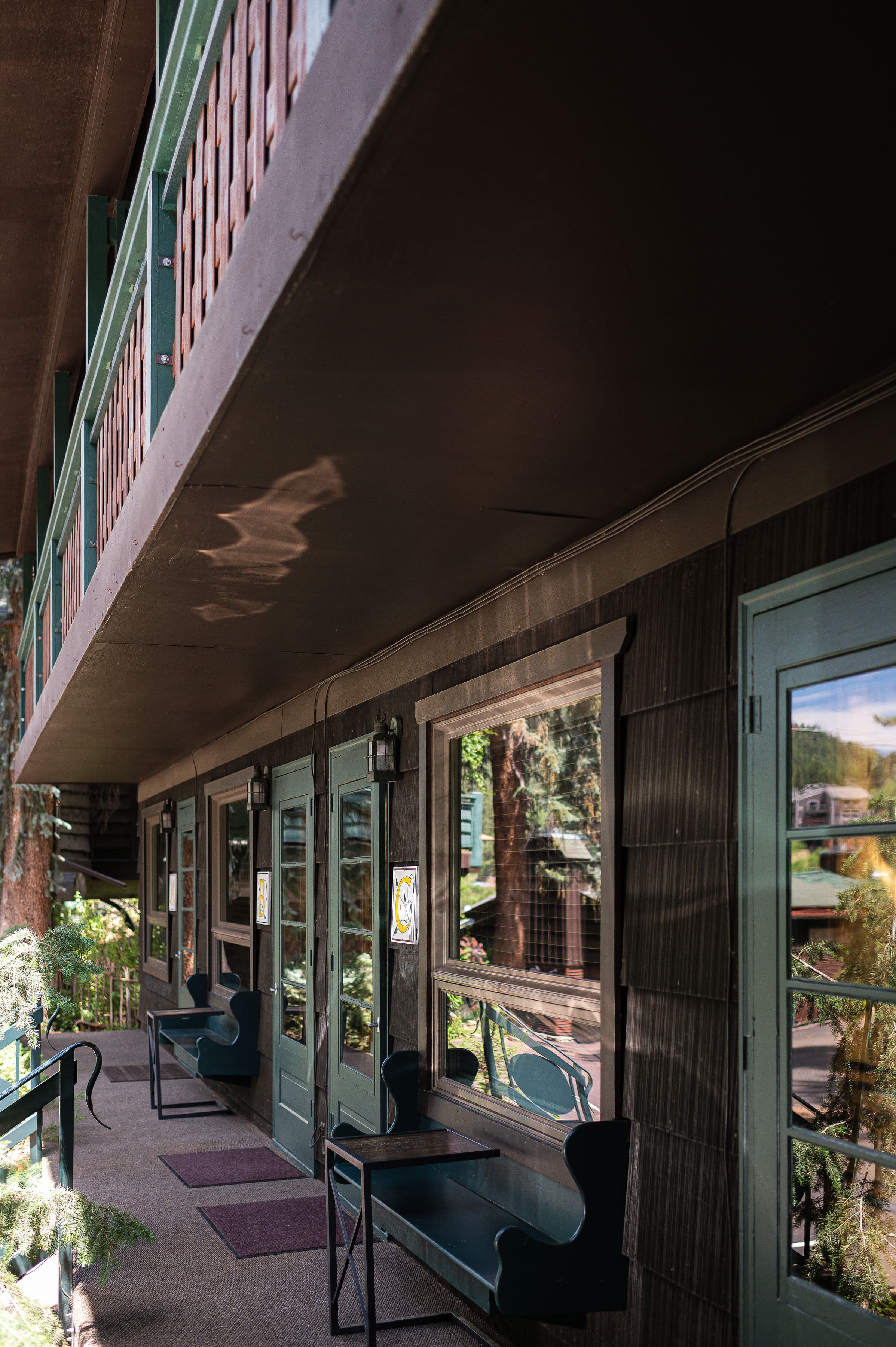 picture of exterior of building with a row of room doors