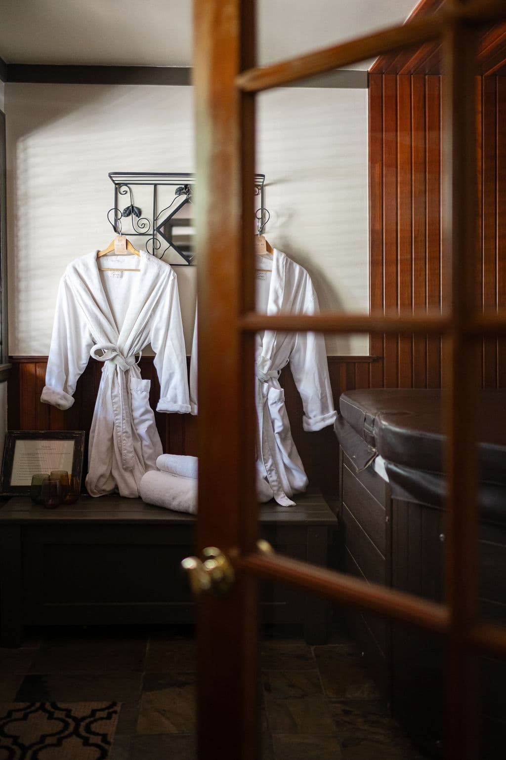 white robes, wooded room with large hot tub