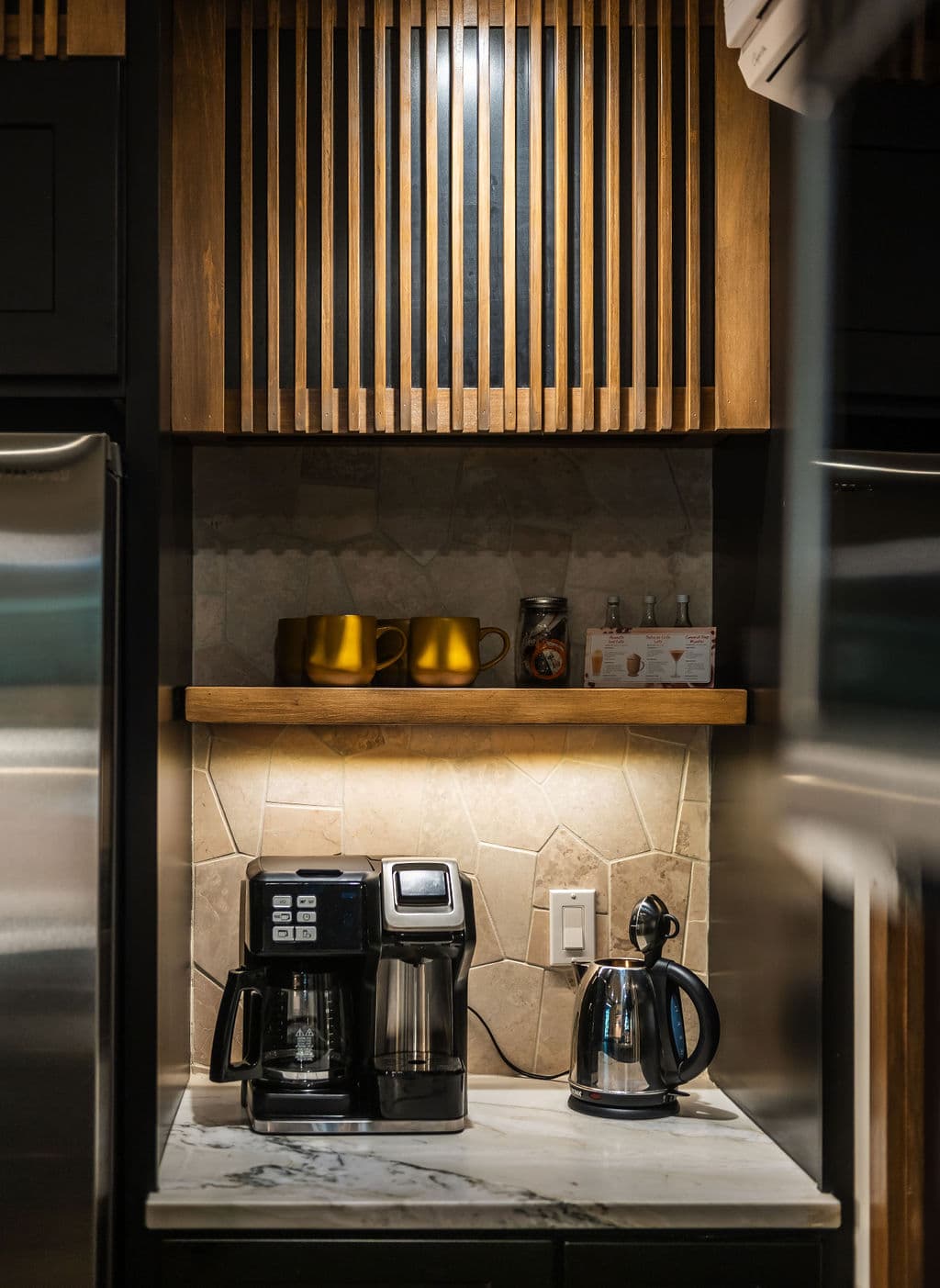 Coffee bar with a tea kettle, keurig and coffee pot combo.
