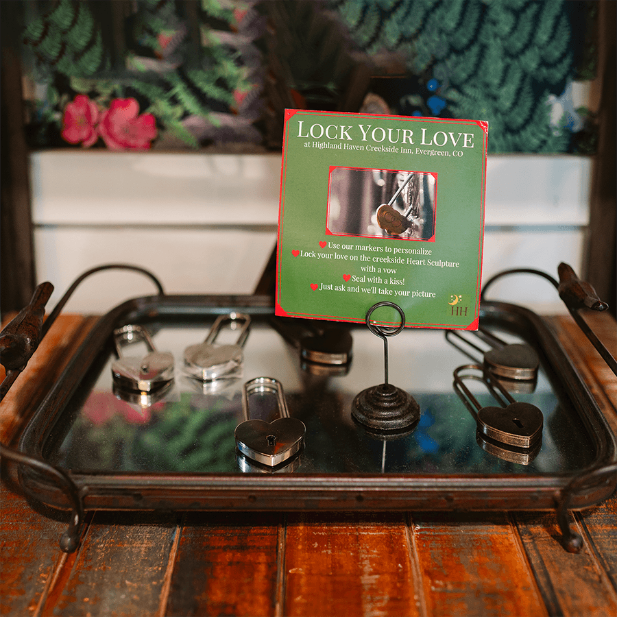 A tray displays a sign inviting guests to "Lock Your Love" with personalized padlocks at Highland Haven Creekside Inn.