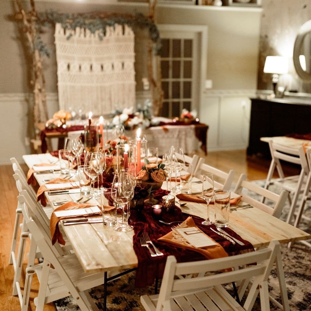 A beautifully set dining table with elegant floral arrangements and candlelight.